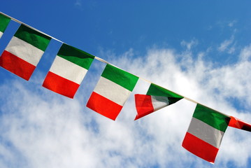 five italian flags wave in the sky