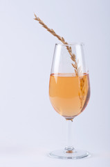 A glass filled with orange substance and spice #1