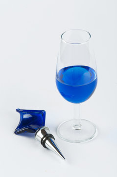 A glass filled with blue substance and an ornament #2