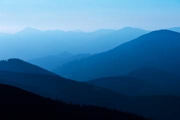 blue color of mountains during sunset