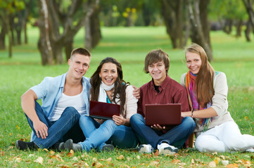 Group of smiling young students outdoors