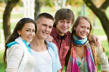 Group of smiling young students outdoors