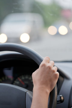 Drivers's hands on a stearing wheel of a car