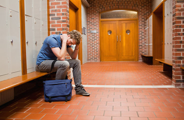 Sad student sitting on a bench