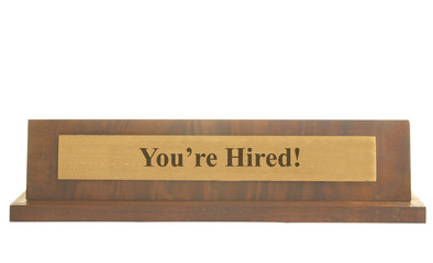 Isolated nameplate with You're Hired text on it
