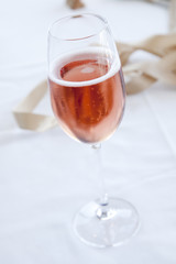 Pink sparkling wine on a white cloth