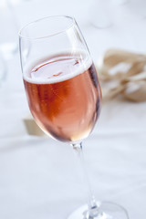 Pink sparkling wine on a white cloth