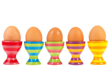 Colorful row with eggs in cups