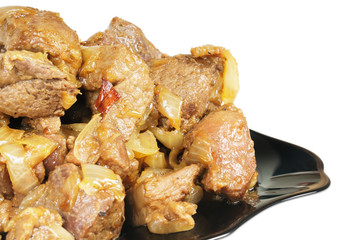 Stew with onions on a plate.