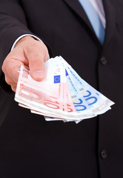 Croped image of a business man offering money