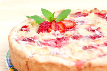Strawberry pie decorated with ripe strawberry, mint and almond f
