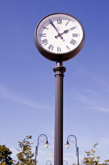 Fototapeta na wymiar street clock and two lamps