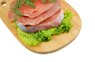 Raw beef meat with greens on cutting board