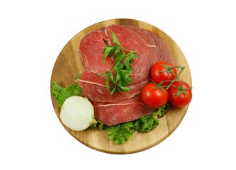 Raw beef meat with fresh vegetables on cutting board