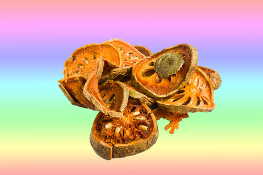 Slices of dried bael fruit on rainblow background