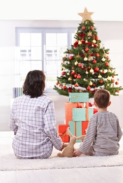 Mom and son looking at christmas tree