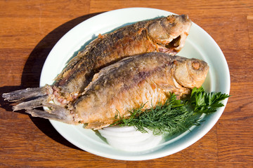 Fried fish crucian in plate