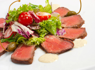 roasted meat with salad and tomato