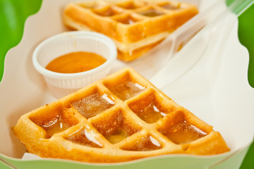 waffle and honey in paper plate