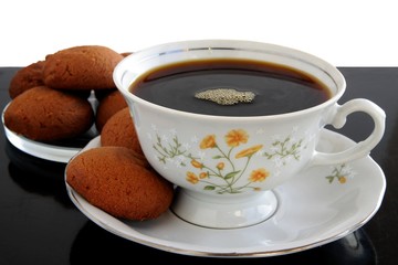 cup of black coffee and cocoa brown cakes