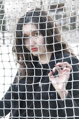 Girl behind the net