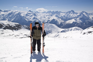 Fototapeta na wymiar Young skiing man standing in snow mountain landscape