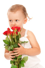 Little girl holding a bouquet of red roses