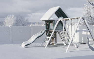 A playground covered in freshly fallen snow
