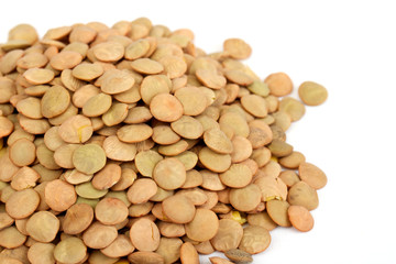 Pile of green lentils from low perspective isolated on white.