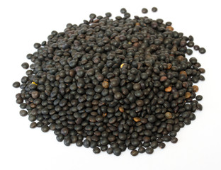Heap of black lentil isolated on white