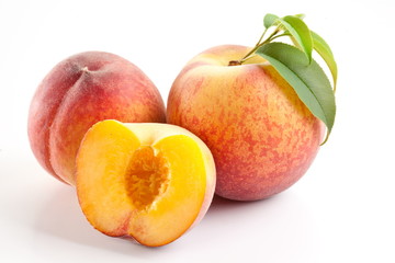 Ripe peach fruit with leaves and slises