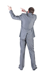 Businessman pointing at wall. rear view.