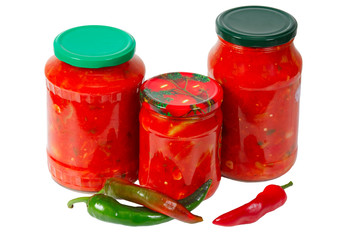 Home canned vegetables in glass jars and peppers