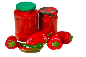 Home canned vegetables in glass jars and peppers