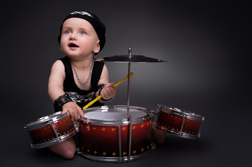 dark portrait of  Beautiful boy playing the drums