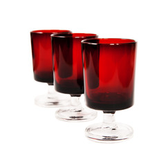 three dark-red glasses
