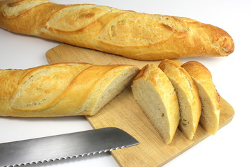 Sliced fresh baguette  and bread knife