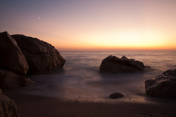 Sun set and rocks at sea