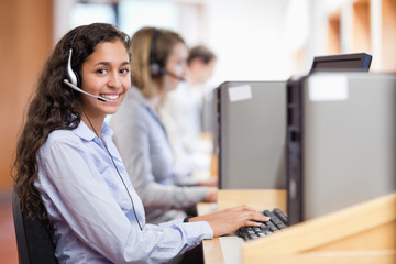 Smiling assistant working with a computer