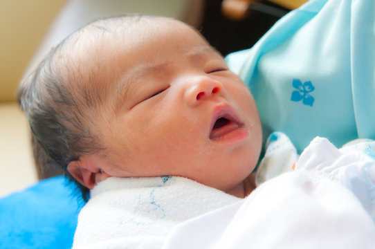 Face of Asian female newborn fall asleep