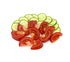 Tomatoes and cucumbers on white background