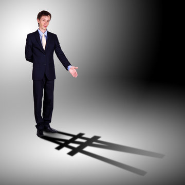 Businessman with shadow as a currency symbol