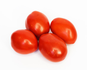 Four ripe tomatoes isolated on white background