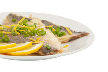 Two pieces of fried fish and lemon segment