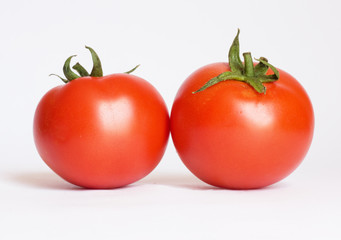 Two tomatoes isolated on white background