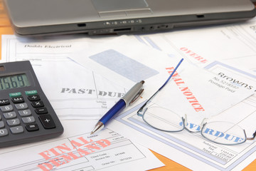 Overdue Bills with Calculator and Laptop