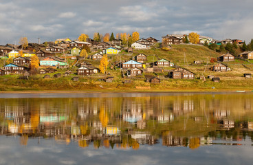 Fototapeta premium Big village on a hill over the river in Komi region, Russia