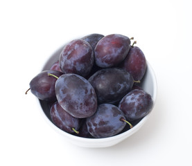 full bowl of plums close-up