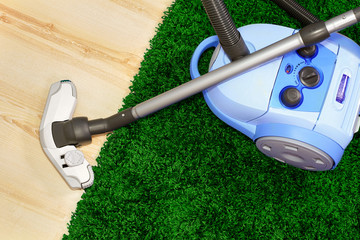 Vacuum cleaner stand  on green  carpet