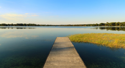 Tranquil lake with long pier